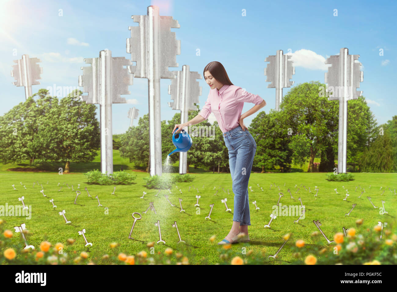 Touches d'arrosage femme sortant de la terre comme les plantes, pré vert sur l'arrière-plan. Idée Concept Banque D'Images