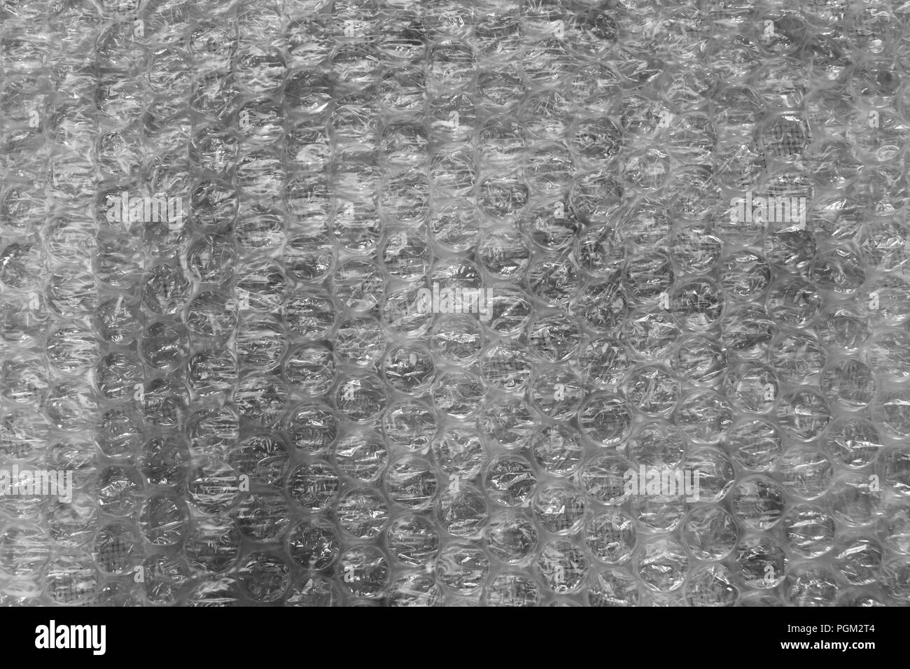 L'enveloppe de bulle la texture utilisée pour l'emballage des objets fragiles sur fond gris Banque D'Images