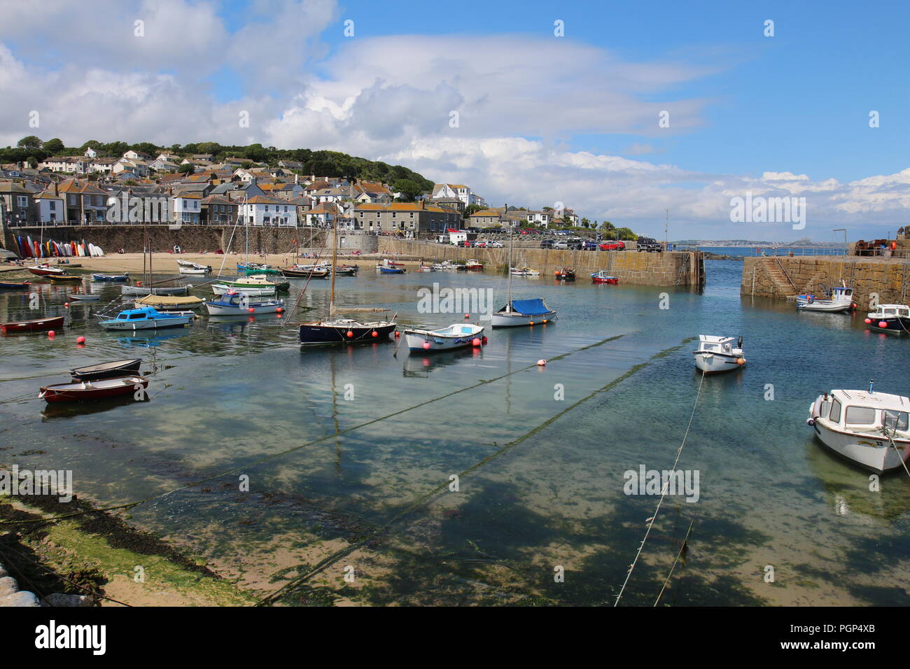 Juin 2015 : bateaux amarrés dans le port Mousehole, Cornwall, UK ; ce petit port a été construit pour assurer la protection de pêcheur au cours de l'hiver féroce stor Banque D'Images