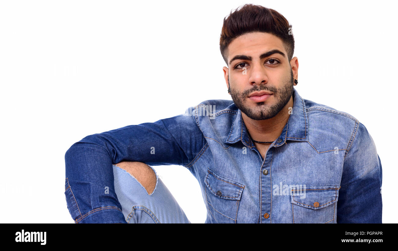 Studio shot of young handsome Indian man isolated on white Banque D'Images