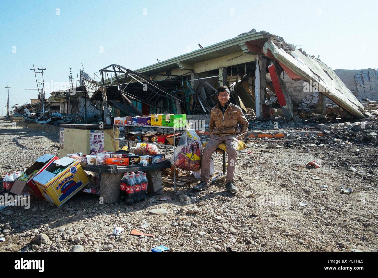 Une vente de boissons et de la nourriture devant la ruine d'un bâtiment à Qaraqosh la ville chrétienne détruit par ISIS Banque D'Images