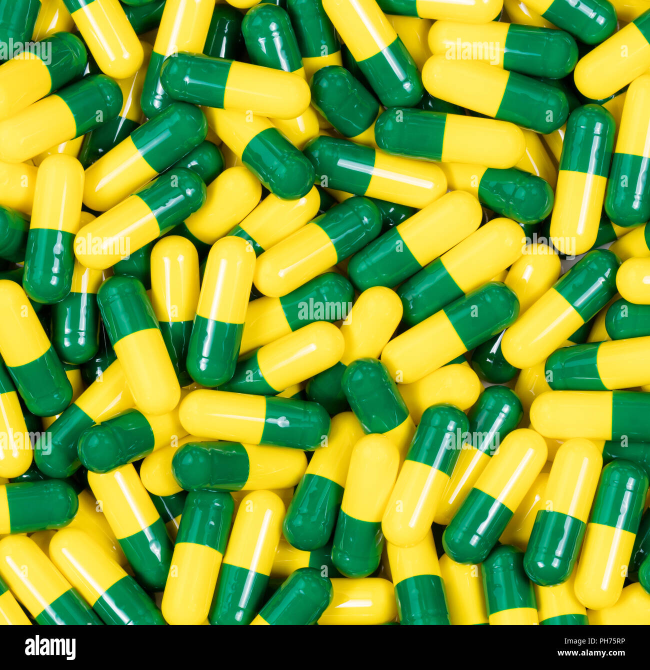 Les capsules de médicaments en vert et jaune Banque D'Images