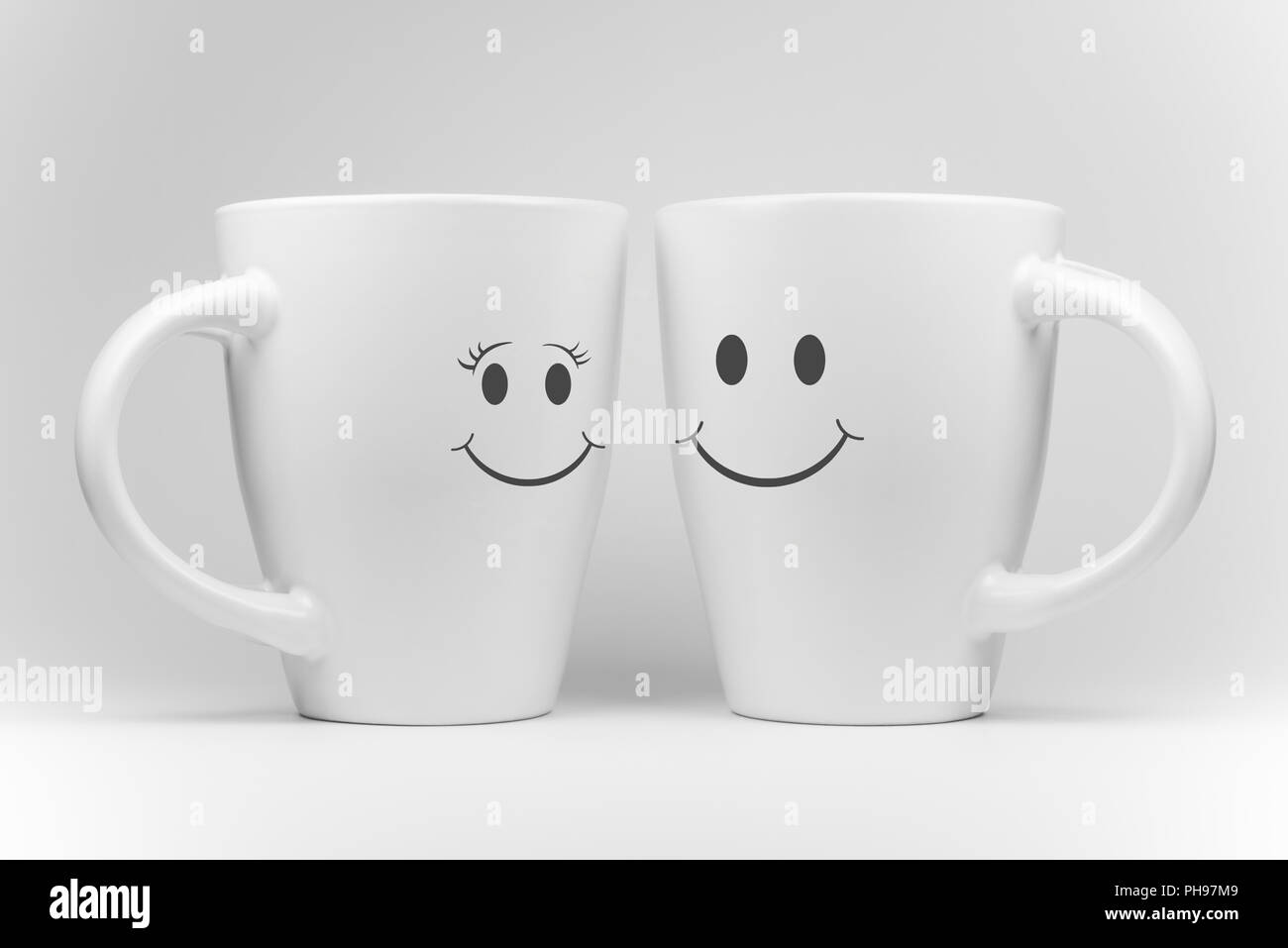 Deux tasses de blanc avec des expressions faciales Banque D'Images
