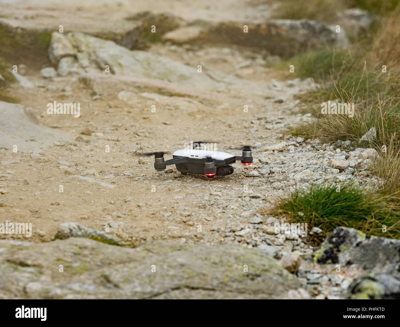 Drone Quadcopter RC moderne / appareil photo avec volant dans la montagne Vysoke Tatry en Slovaquie. Petit dron l'atterrissage sur la piste. Banque D'Images