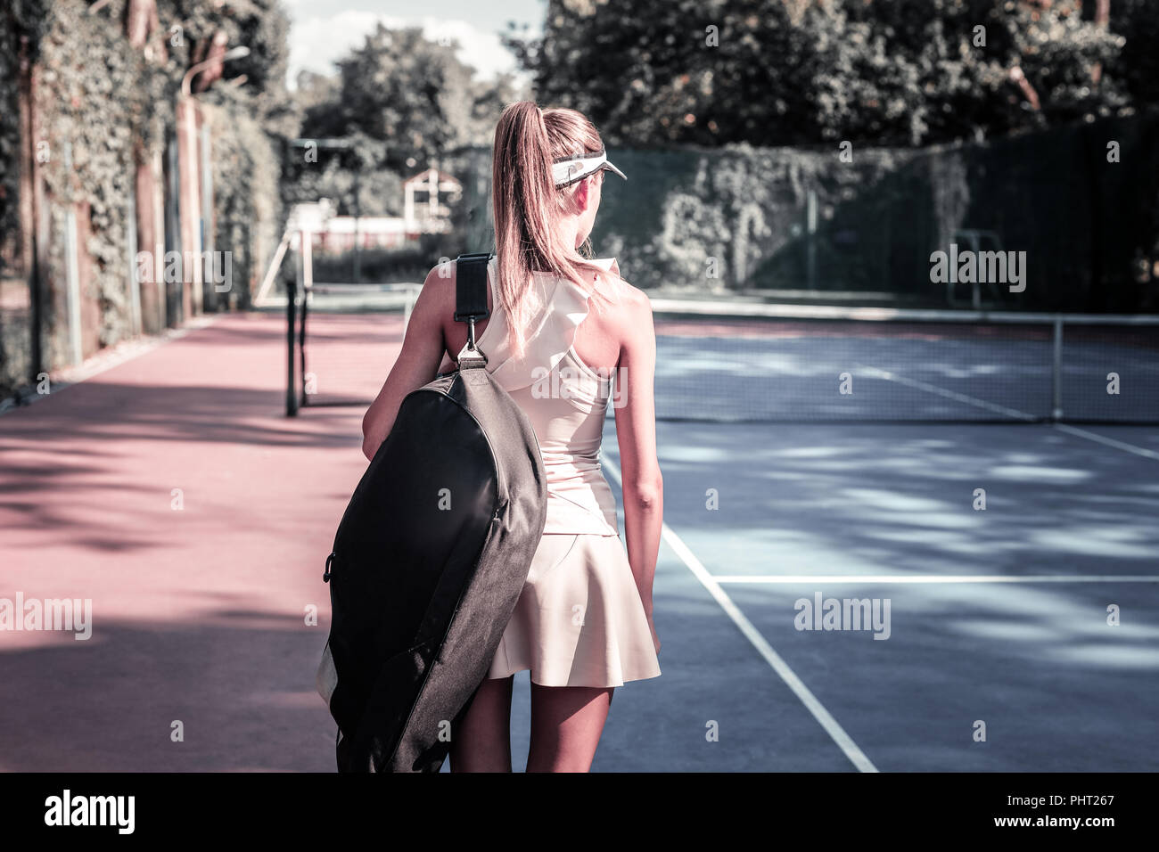 Jeune femme énergique allant de la formation de tennis Banque D'Images