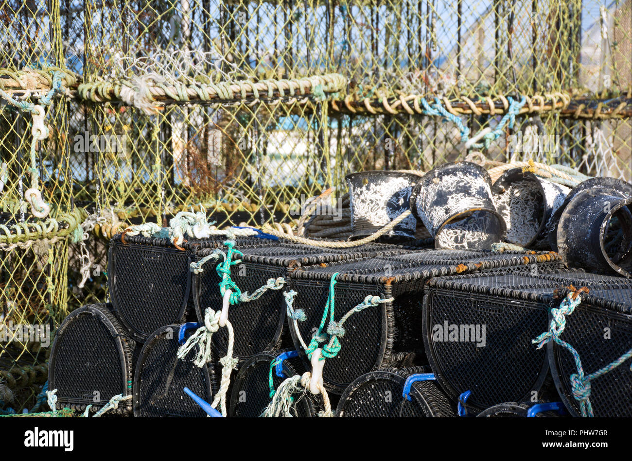 Des casiers à crabe et homard avec next stockés sur quai de port de Poole, dans le Dorset, Angleterre et prêt à l'emploi. Banque D'Images
