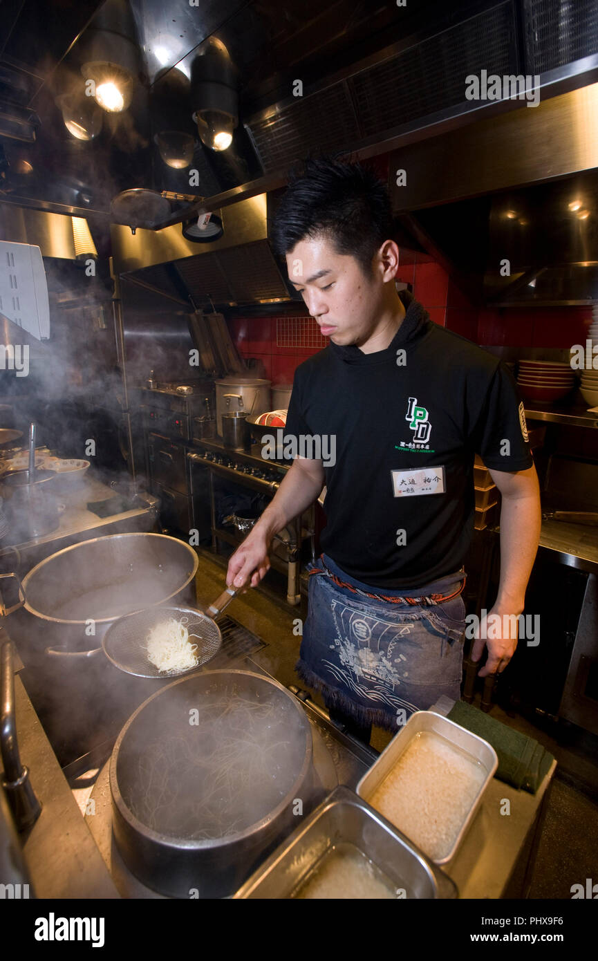 Store Manager Yusuke Osako prépare des nouilles dans la cuisine à Hakata Ramen Ippudo dans le magasin principal du daimyo du district de la ville de Fukuoka, Fukuoka Préfet Banque D'Images