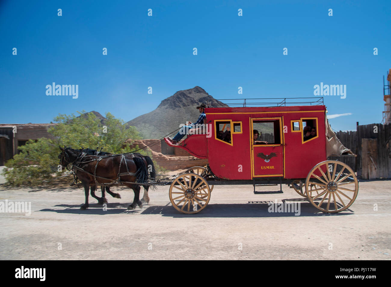 Old West red stage coach tiré par deux chevaux. Banque D'Images