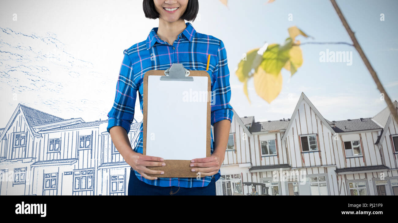 Image composite de female architect holding clipboard contre l'arrière-plan gris Banque D'Images