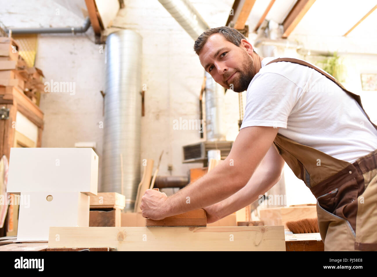 Carpenter travaille dans un atelier de menuiserie - pour le travail du bois et sciage Banque D'Images