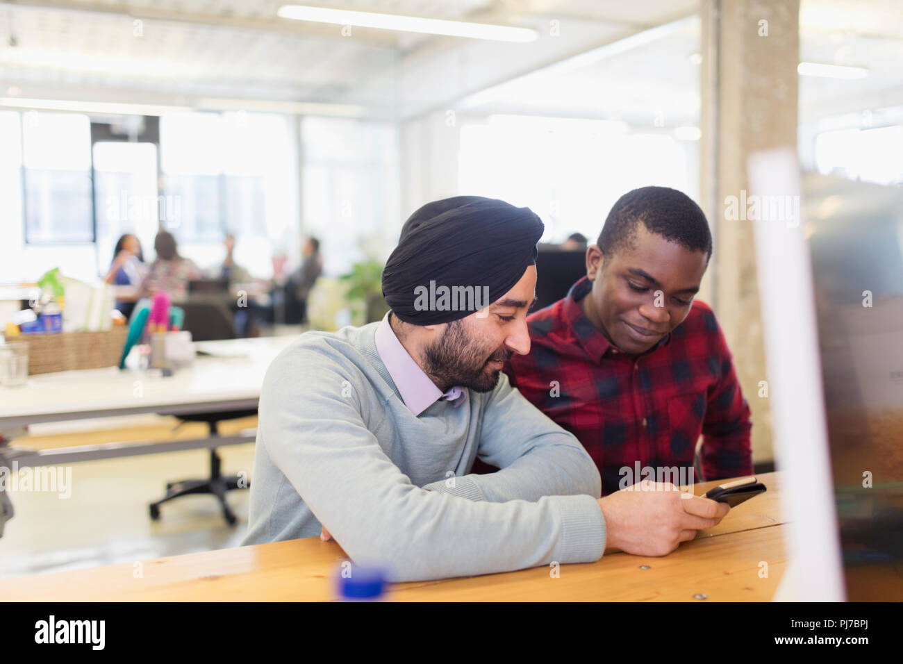 Les hommes d'affaires à l'aide de smart phone in office Banque D'Images