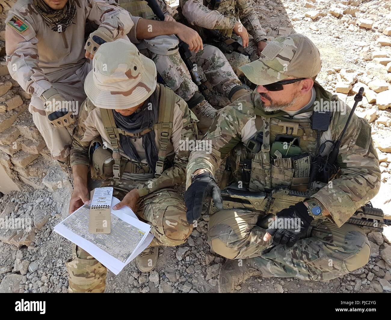 KANDAHAR, AFGHANISTAN (10 juillet 2018) -- une coalition de la finale de l'attaque conjointe (JTAC) deux trains de conseiller des Forces territoriales membres 444 afghans de Commandement général des forces spéciales de l'unité (GCPSU) d'identifier des cibles sur le champ de bataille au cours d'un air-sol, à l'exercice d'intégration gamme Tarnak, province de Kandahar, Afghanistan, 9-10 juillet 2018. Au cours de l'exercice de deux jours, plus de 50 contrôleurs aériens tactiques afghans des deux carburants de 444 et la Mission spéciale Wing, conseillé par les États-Unis et ses partenaires de la Coalition, les frappes aériennes dirigées sur des cibles statiques simulée. (Photo OTAN/libérés) Banque D'Images