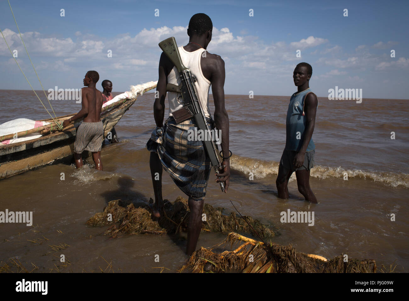Les pêcheurs kenyans armés se préparer à naviguer leur bateau pendant une expédition de pêche sur le lac Turkana, au nord du Kenya, le 4 novembre 2012 Banque D'Images