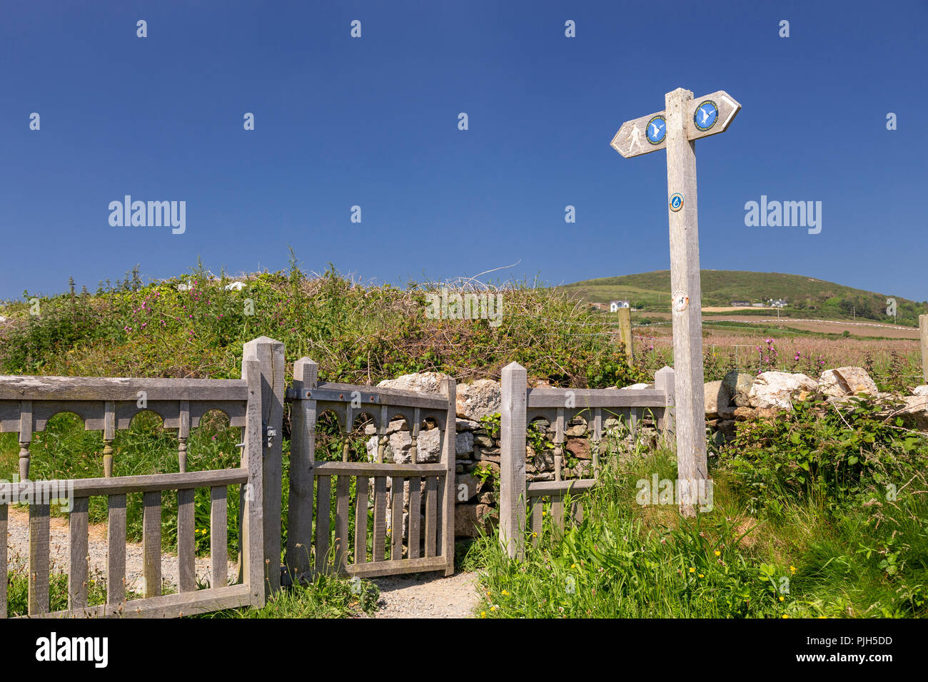 Sentier du littoral d'Anglesey et porte à l'Église d'orientation Bay, Anglesey, au nord du Pays de Galles sous le soleil d'été Banque D'Images