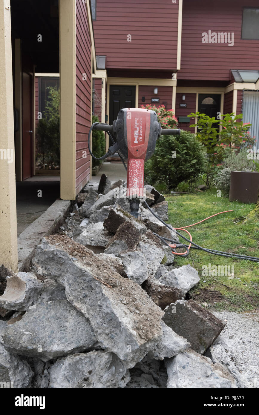 Prise électrique Hilti hammer placés dans un tas de nouvelles pièces de béton. Banque D'Images