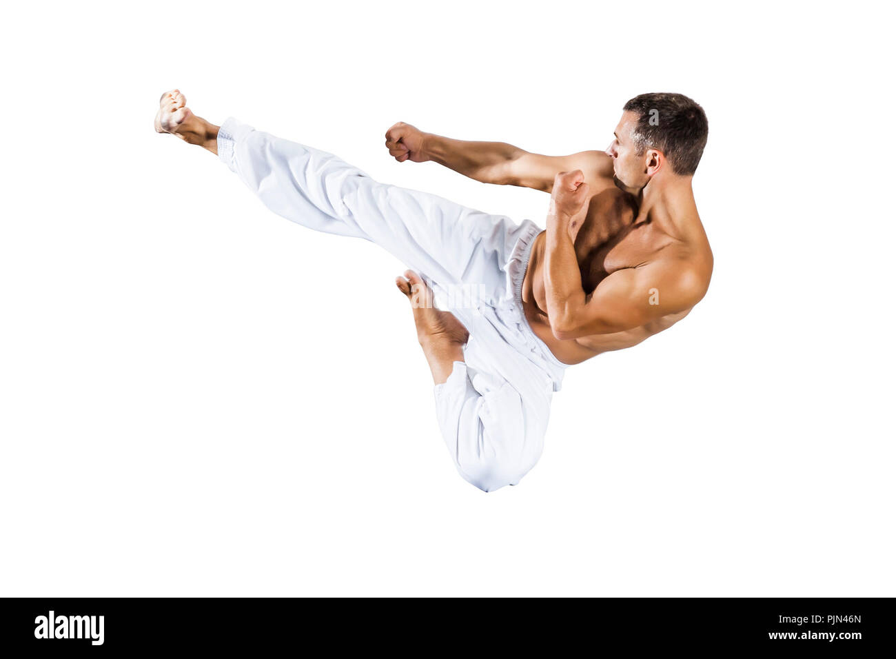 Un maître de taekwondo dans le saut avant fond blanc, Ein im Taekwondo-Meister vor weissem Hintergrund Sprung Banque D'Images