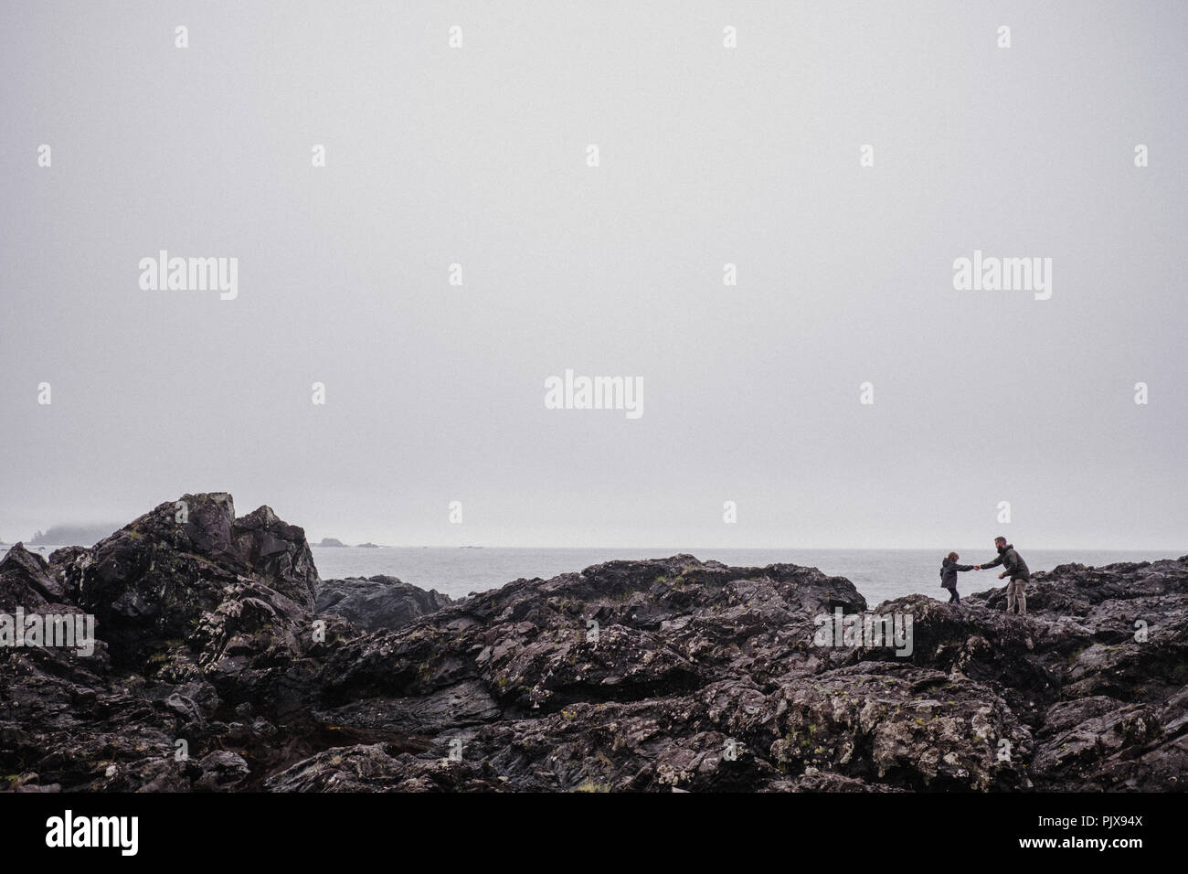 Le père et l'enfant marche sur les roches, Tofino, Canada Banque D'Images