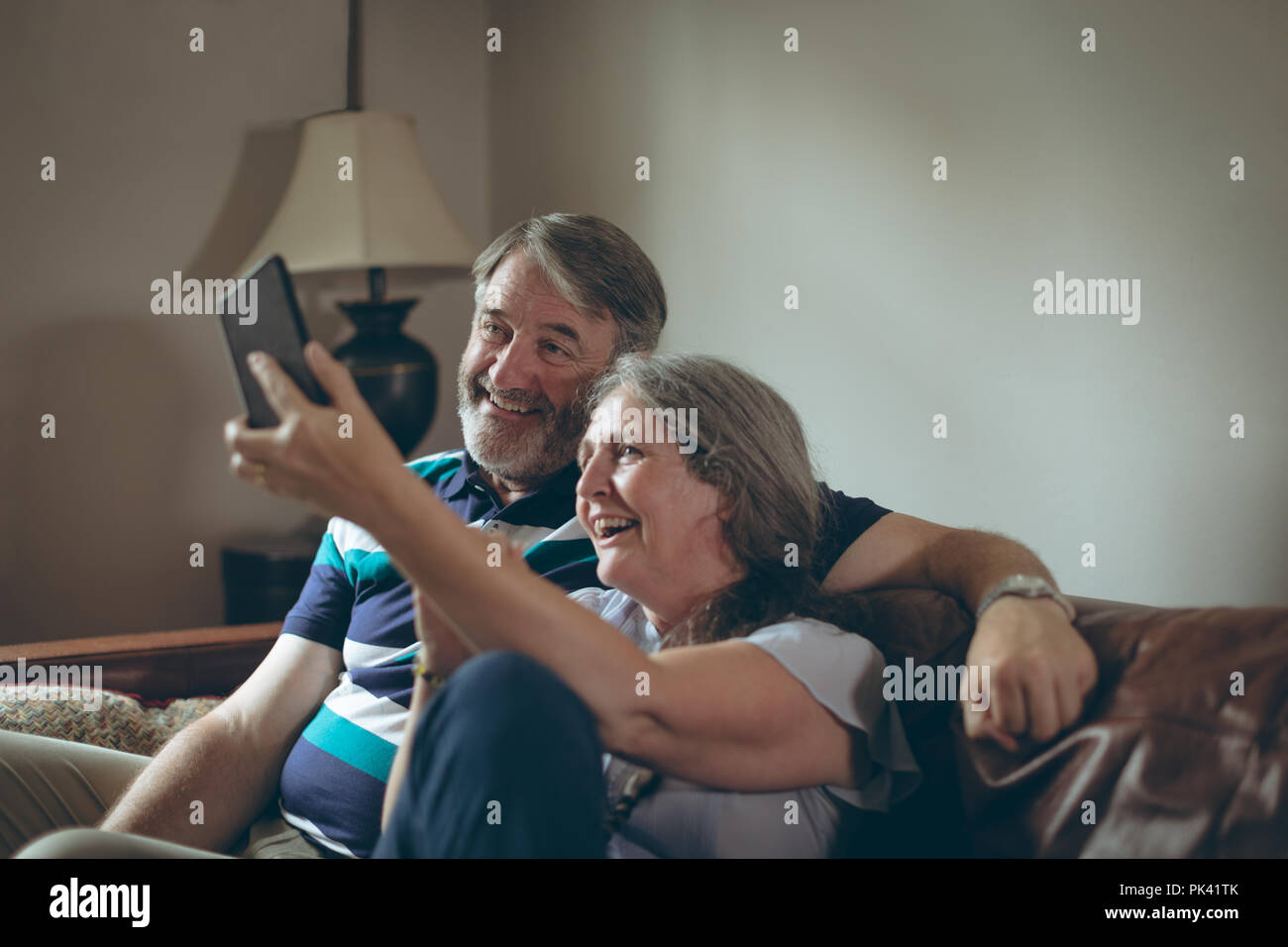 Young couple on mobile phone selfies at home Banque D'Images
