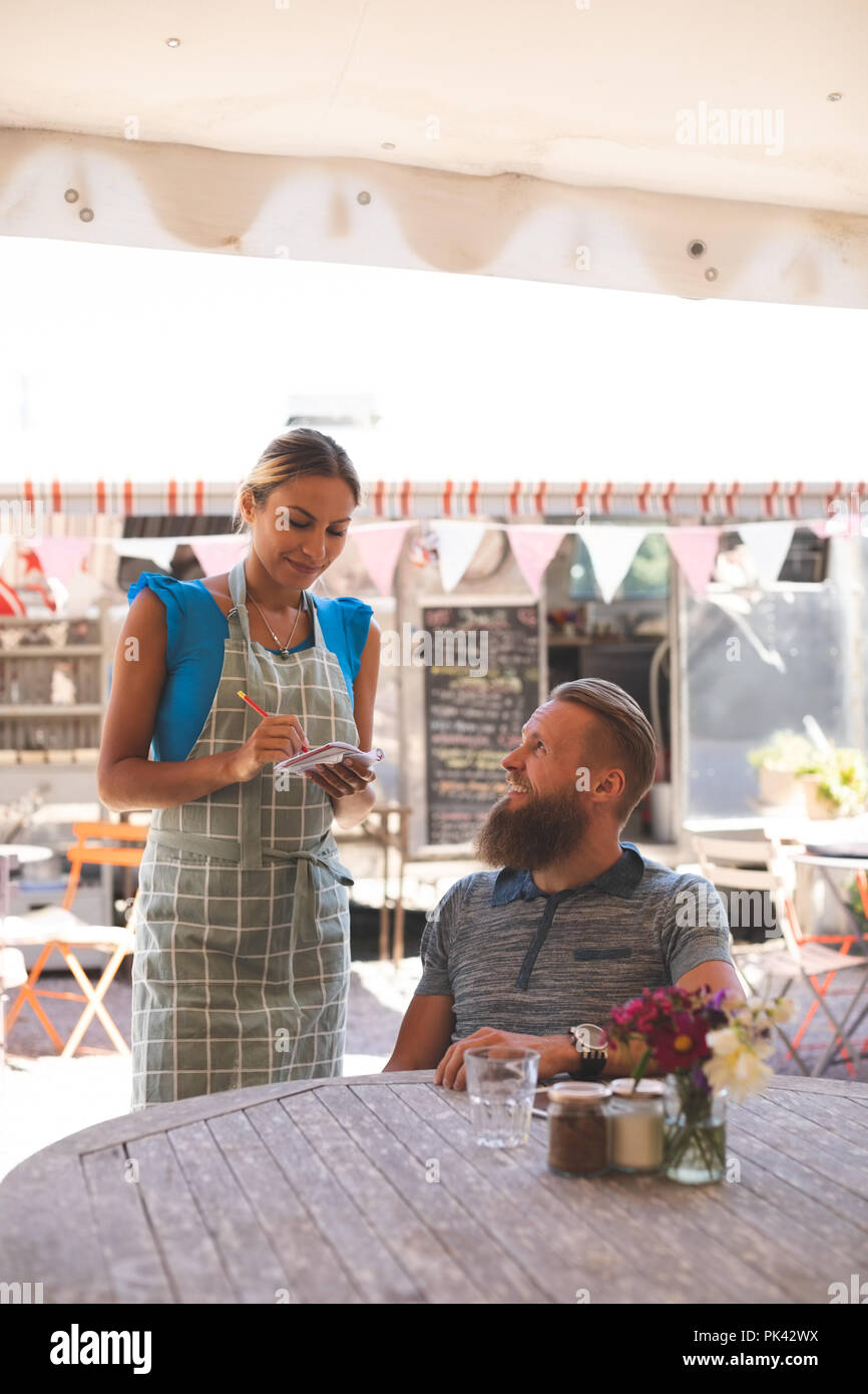 Femme waitress in outdoor cafe Banque D'Images