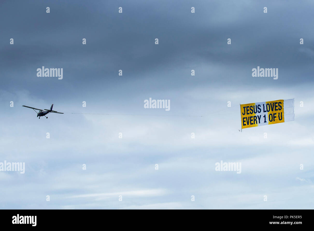 Un petit avion de remorquage d'une bannière avec un message religieux. Banque D'Images