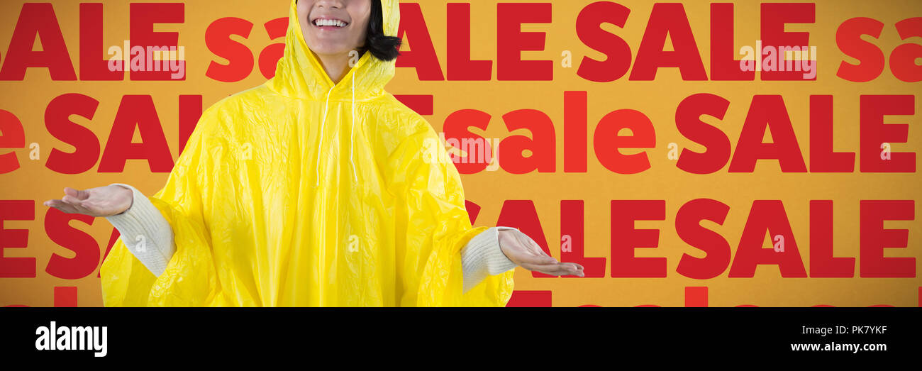 Image composite de la femme en imperméable jaune gesticulant de sentir la pluie Banque D'Images