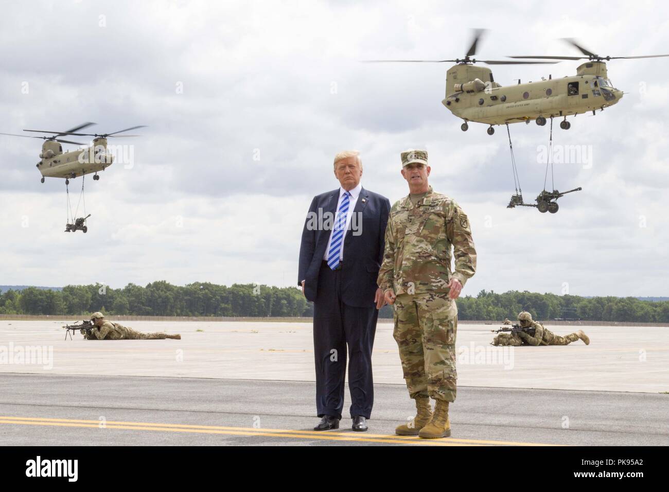 Le président Donald J. Trump et le Major-général Walter E. Piatt, commandant de la 10e Division de Montagne (LI), regardent le CH-47 Chinook transporter de l'artillerie pendant une manifestation à Fort Drum, New York, le 13 août, 13 août, 2018. La démonstration faisait partie du président Donald J. Trump dans la 10e Division de Montagne (LI) à signer le National Defense Authorization Act de 2019, qui augmente l'armée en service actif autorisé par la force fin 4 000, ce qui nous permet de capacités critiques sur le terrain à l'appui de la stratégie de défense nationale. (U.S. Photo de l'armée par le Sgt. Thomas Scaggs) -Un-TZ47 Banque D'Images