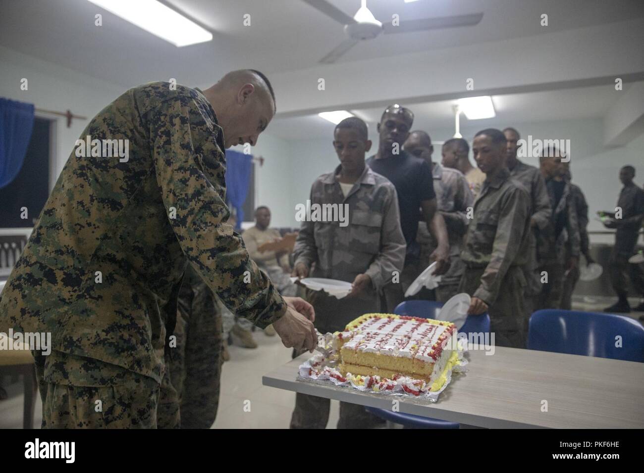 Le Sgt. Le Major Adam Sheinkin, le Groupe de travail air-sol marin - sergent-major de commandement sud, coupe un gâteau pour Marines avec SPMAGTF-SC's Mobile Training Team 1 et leurs élèves dans l'infanterie de marine de la République dominicaine au cours d'un dîner du "guerrier" après un 10-mile randonnée dans la région de Las Calderas, la République dominicaine, le 2 août 2018. La randonnée a fait partie de l'infanterie avance bien sûr des compétences enseignées par les Marines aux dominicains. Les Marines et les marins d'SPMAGTF-SC mènent la coopération de sécurité et de formation projets d'ingénierie avec des forces militaires de la nation en Europe centrale et du Sud Banque D'Images