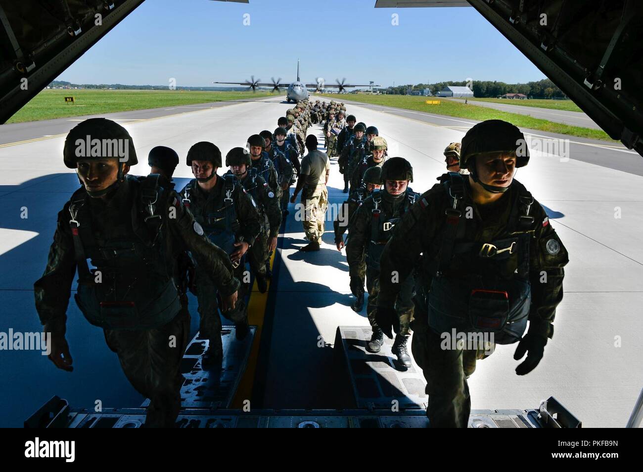 Les parachutistes polonais un conseil U.S. Air Force C-130J Super Hercules au cours de l'effort de rotation aérienne 18-4 à Cracovie, Pologne, le 7 août 2018. Les opérations de largage le menées pendant la rotation de l'aviation ont été sauts en ligne statique et de grande ouverture Altitude-Low sauts. Banque D'Images