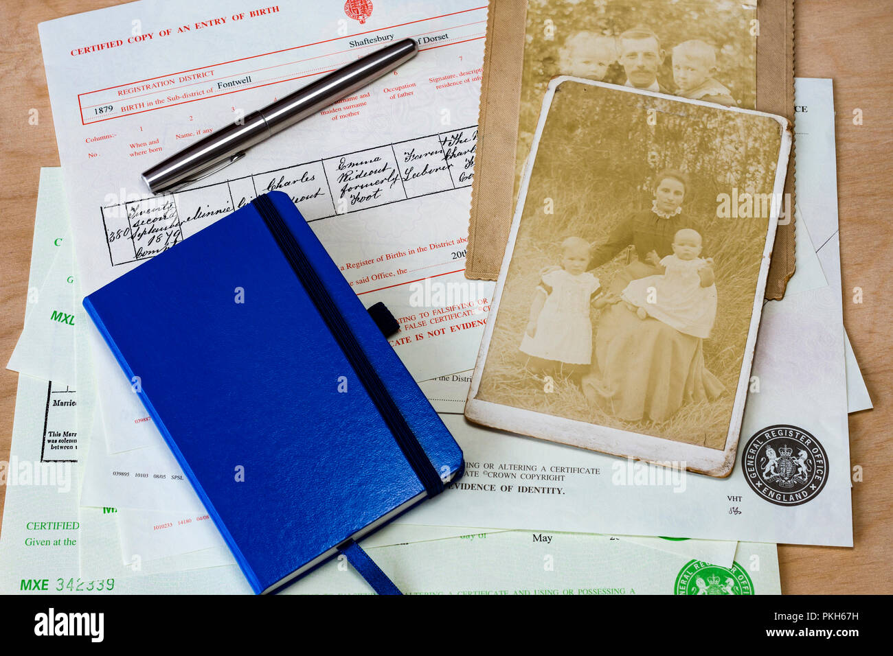 Collection de naissance, de mariage, de décès et d'un ordinateur portable avec quelques vieilles photographies utilisées pour la recherche généalogique, England, UK Banque D'Images