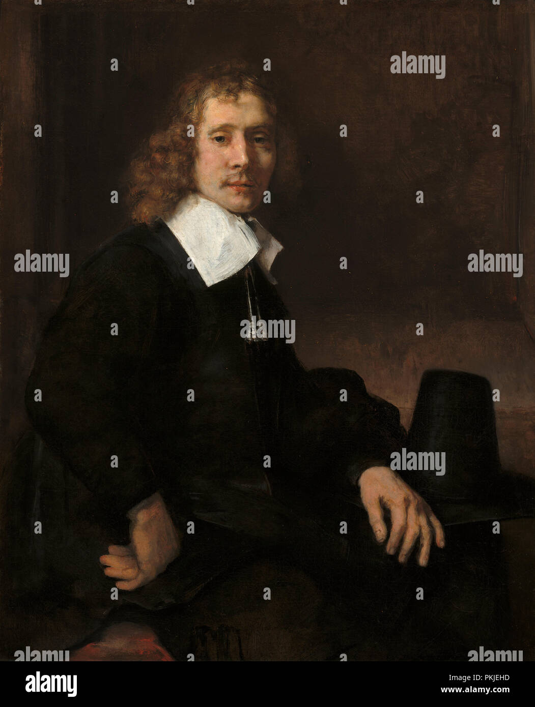 Un jeune homme assis à une table (éventuellement Govaert Flinck). En date du : ch. 1660. Dimensions : hors tout : 109,9 x 89,5 cm (43 1/4 x 35 1/4 in.) : 149,2 x 131,1 encadrée x 17,8 cm (58 3/4 x 51 5/8 x 7 in.). Médium : Huile sur toile. Musée : National Gallery of Art, Washington DC. Auteur : REMBRANDT, Harmenszoon van Rijn. REMBRANDT HARMENSZOON VAN RIJN. Banque D'Images