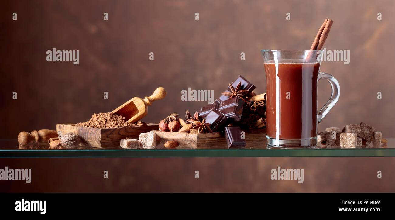 Avec cacao cannelle, morceaux de chocolat et d'épices diverses sur un fond brun. Copie de l'espace pour votre texte. Banque D'Images