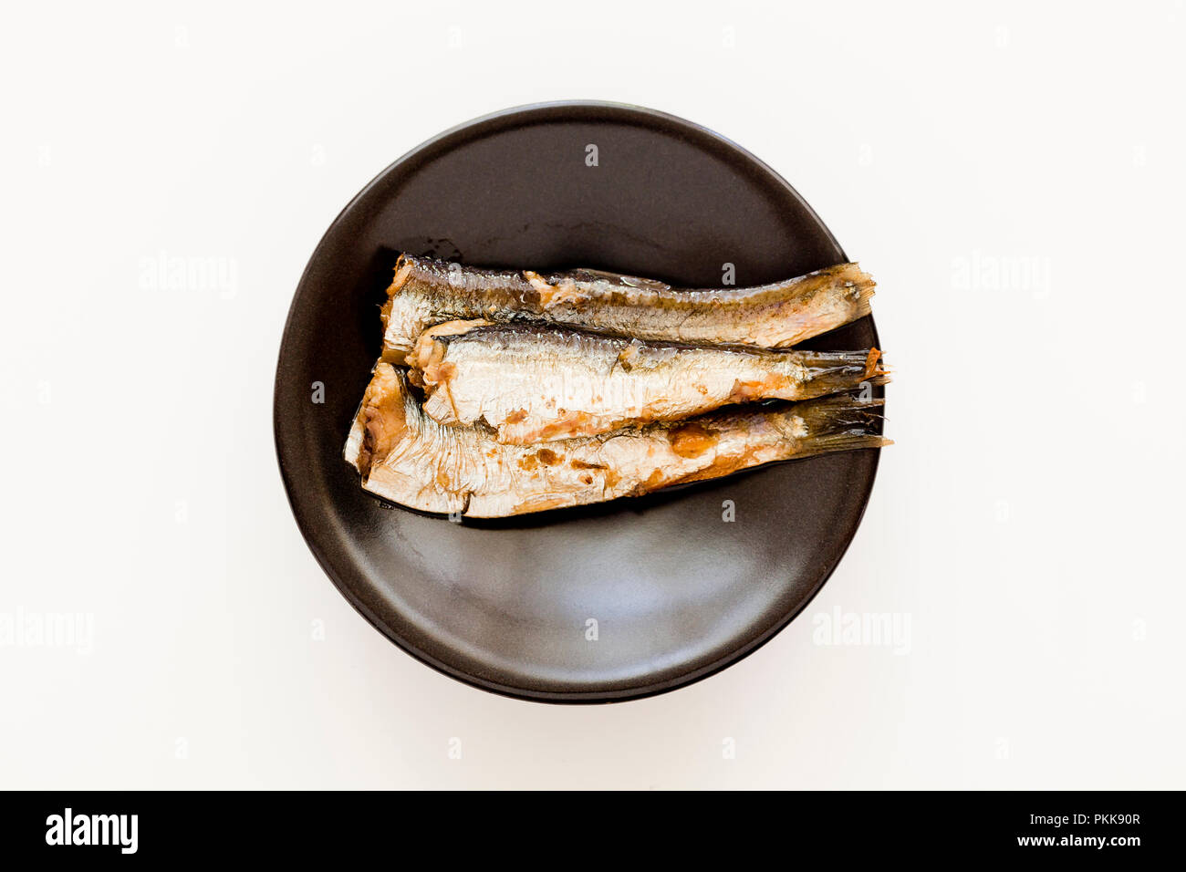 Les sardines (aka pilchards) mariné à l'huile d'olive sur plat - USA Banque D'Images