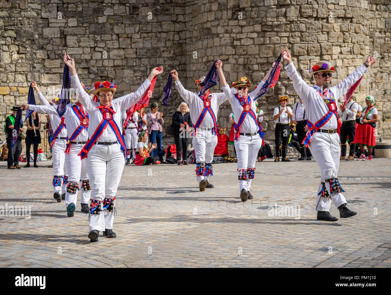 Un groupe de femmes et d'hommes Morris Dancers exécuter une danse Morris en face de la Murs de Southampton, Southampton, Hampshire, England, UK Banque D'Images