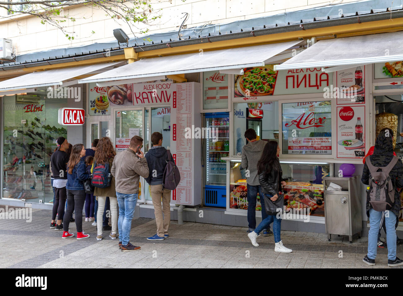 Les gens à l'extérieur d'un fast food typique dans la zone commerciale principale de Plovdiv, en Bulgarie. Banque D'Images