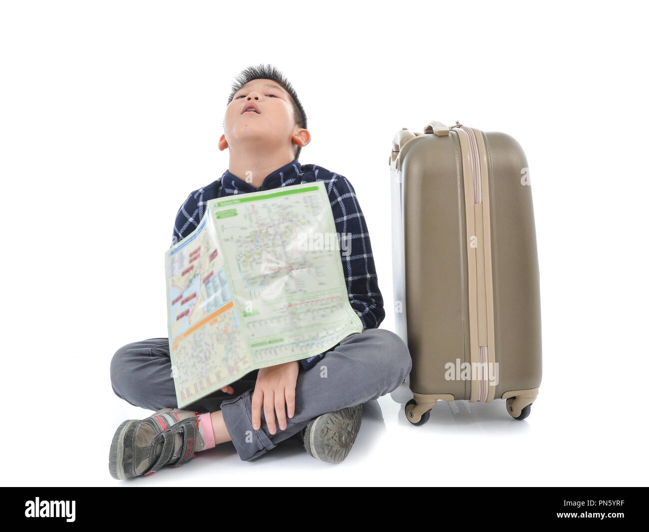 Asian boy holding map et assis avec assurance, isolé sur blanc. Banque D'Images