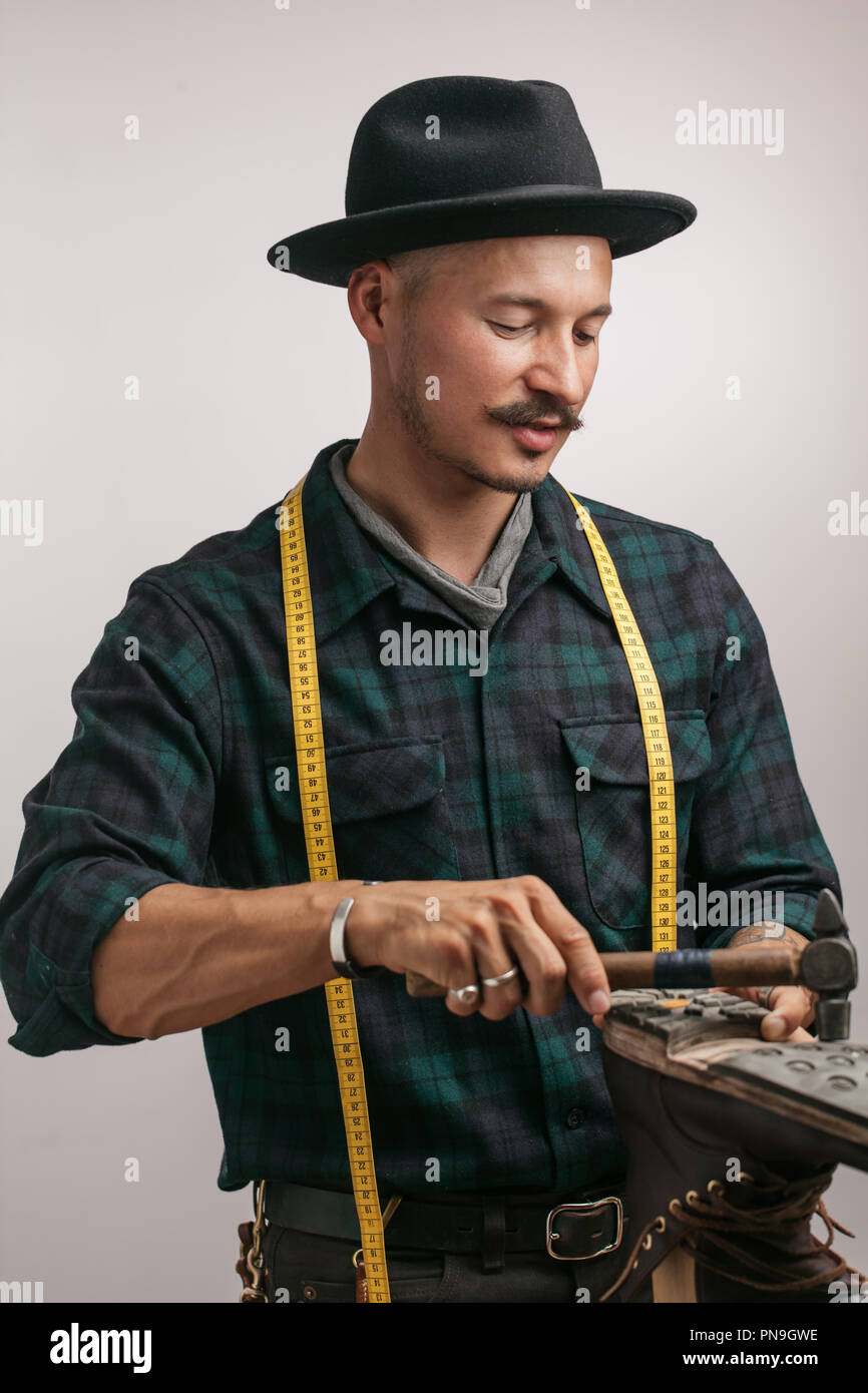 Cordonnier au studio. Méconnaissable shoemaker effectue chaussures dans le craft studio Banque D'Images