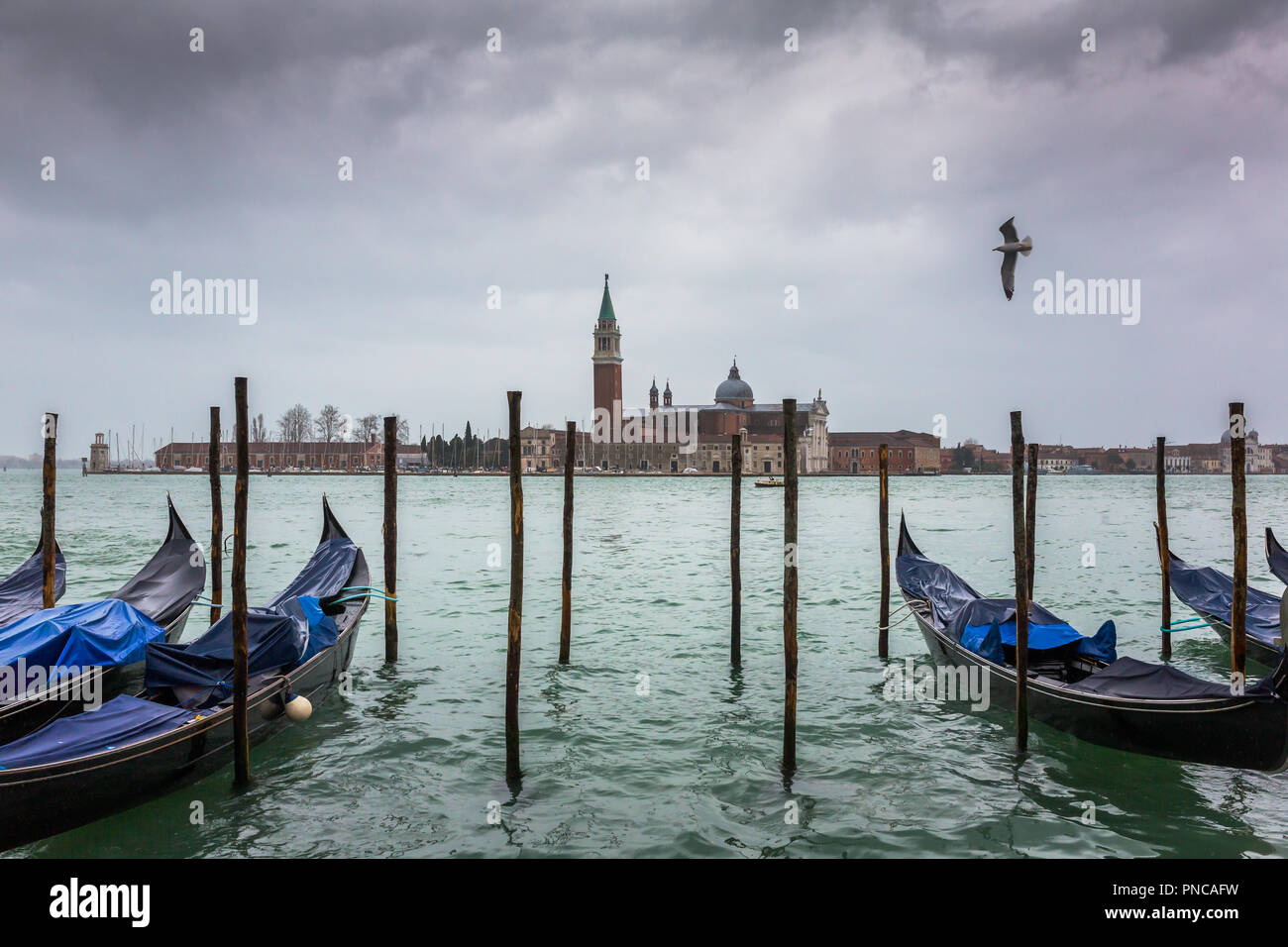 L'église San Giorgio Maggiore et gondoles à jour nuageux à Venise, Italie. Banque D'Images