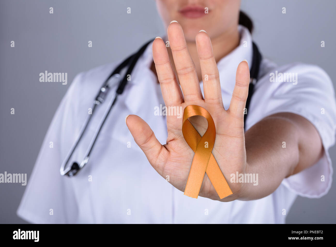 La main de femme médecin avec le ruban de la sensibilisation au cancer de l'utérus montrant Banque D'Images