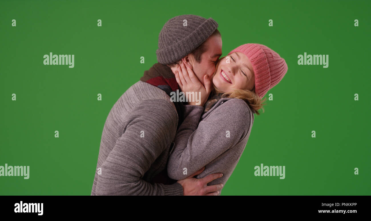 Couple et d'être tendre dans les vêtements d'hiver sur l'écran vert Banque D'Images