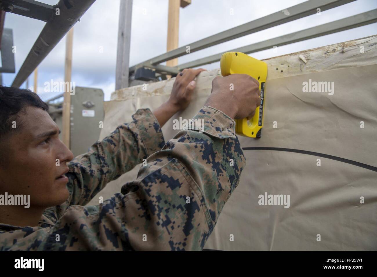 Le Cpl. Justin Lara répare une cible lors d'un cours d'entraîneurs de l'adresse au tir de combat au Camp Hansen, Okinawa, Japon, 14 août 2018. Lara, originaire d'Austin, Texas, est un carabinier avec 2e Bataillon, 3e Régiment de Marines. "Lorsque votre dans les stands juste être sur vos orteils et marquer le tireur ce qu'il tire, dit-il. "Les fosses" désigne la zone que vous rendez à tirer et marquer les cibles à la plage. Banque D'Images