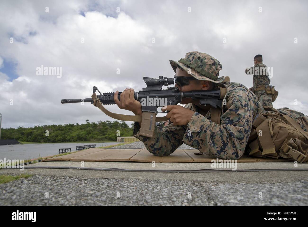 Le Cpl. Justin Lara incendies dans la position ventrale pendant un cours d'entraîneurs de l'adresse au tir de combat au Camp Hansen, Okinawa, Japon, 14 août 2018. Lara, originaire d'Austin, Texas, et d'un fantassin du 2e Bataillon, 3e Régiment de Marines. "Je n'ai jamais touché un pistolet ou une carabine avant le Marine Corps," dit-il. "Je suppose que certaines personnes disent que c'est intéressant, ou bizarre, parce que je suis du Texas." Maintenant Lara apprend à être un entraîneur où il va former plus de 100 Marines américains par an, à la carabine et au pistolet de la compétence. Banque D'Images