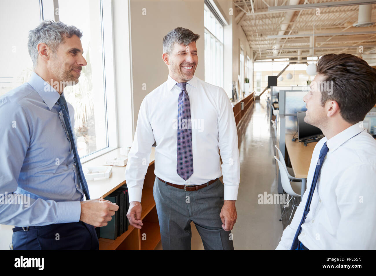 Trois collègues masculins à parler au travail, Close up Banque D'Images