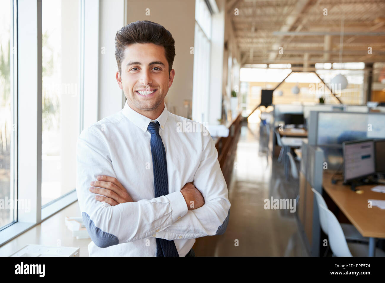 Young Hispanic male architect in office smiling to camera Banque D'Images