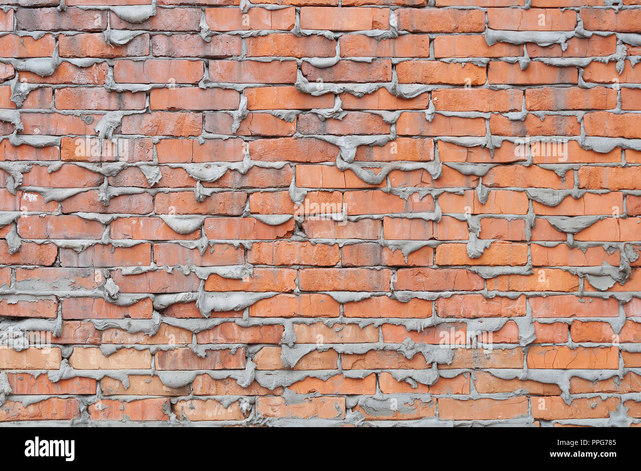 Mur de briques avec le béton durci qui est mal fait. Arrière-plan de texture. Banque D'Images