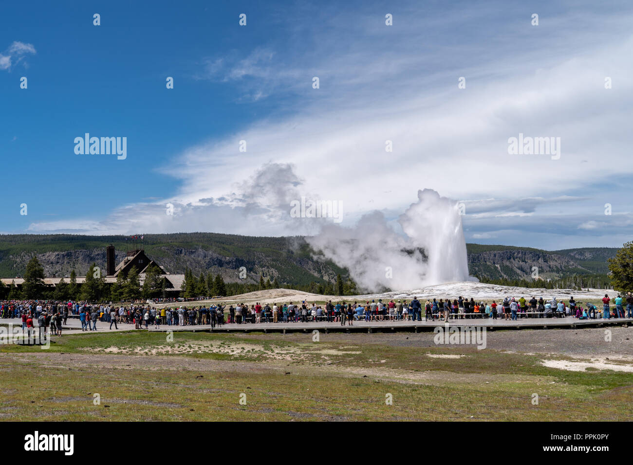 Yellowstone, Wyoming : des foules de touristes et les visiteurs se réunissent autour de la promenade pour regarder Old Faithful Geyser en éruption. Concept pour crowde Banque D'Images