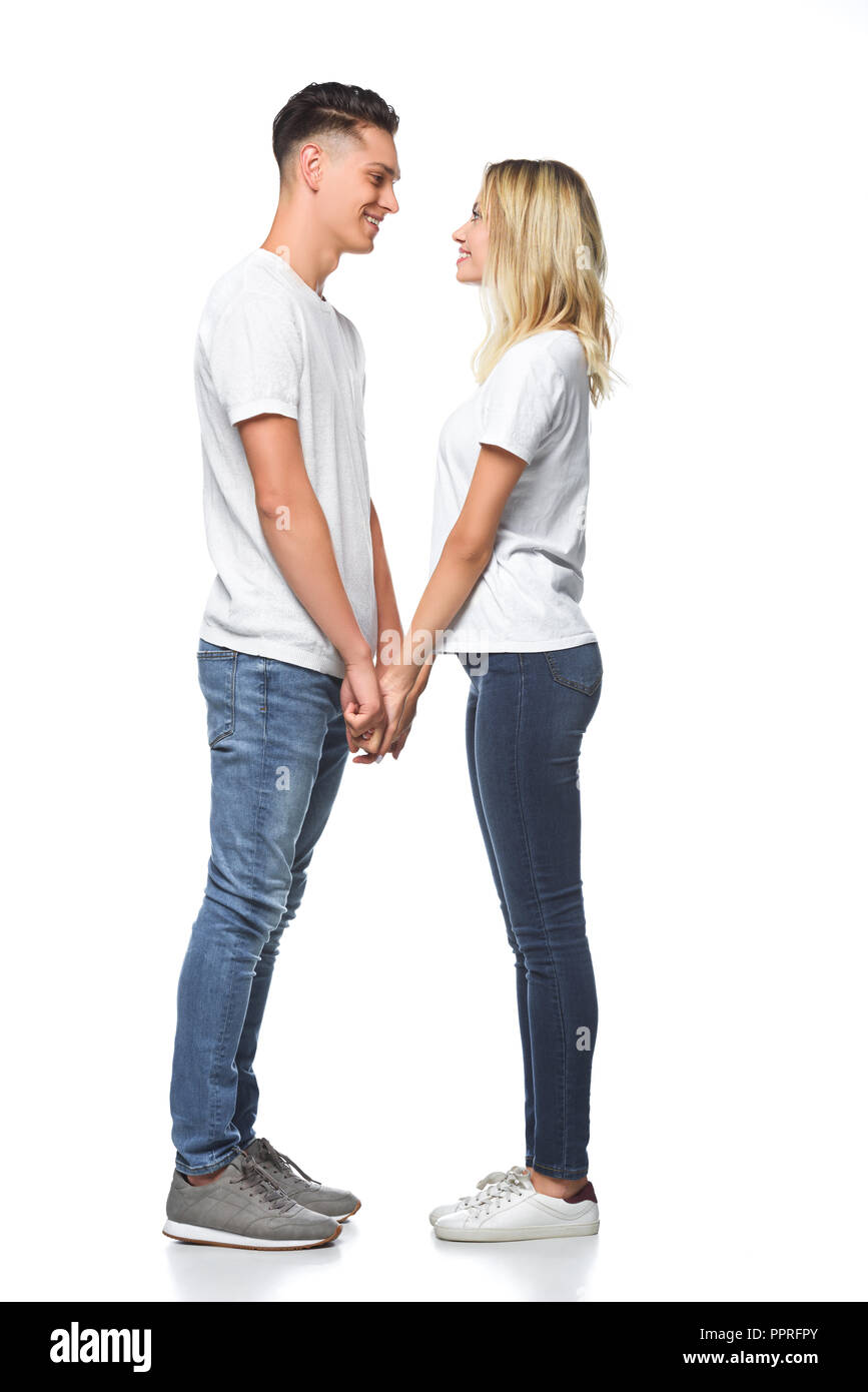 Vue latérale du smiling couple holding hands and isolated on white Banque D'Images