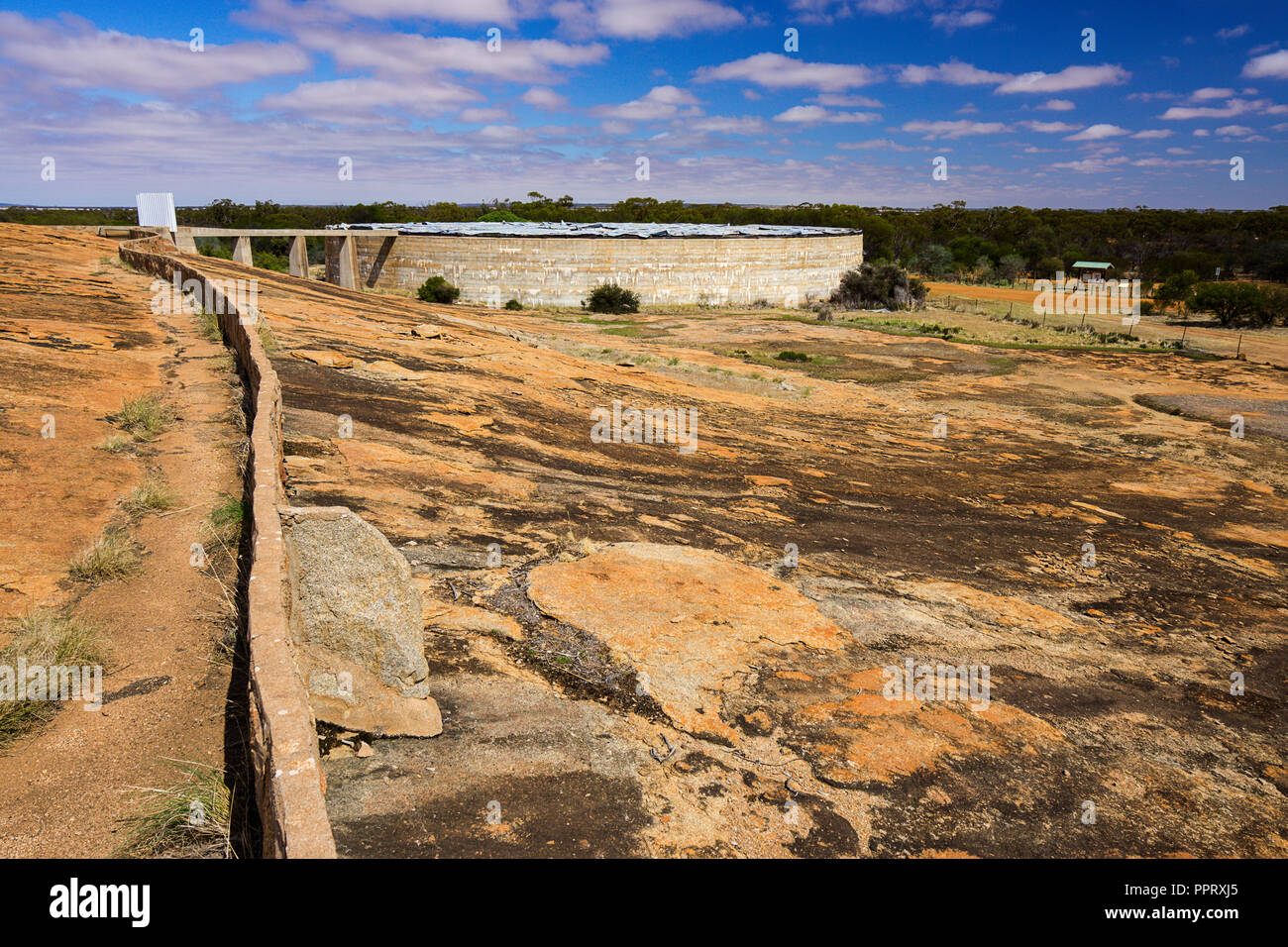 Muret en pierre dirige le ruissellement de l'eau de pluie en réservoir d'eau de pluie à Beringbooding Rock Australie Occidentale Banque D'Images
