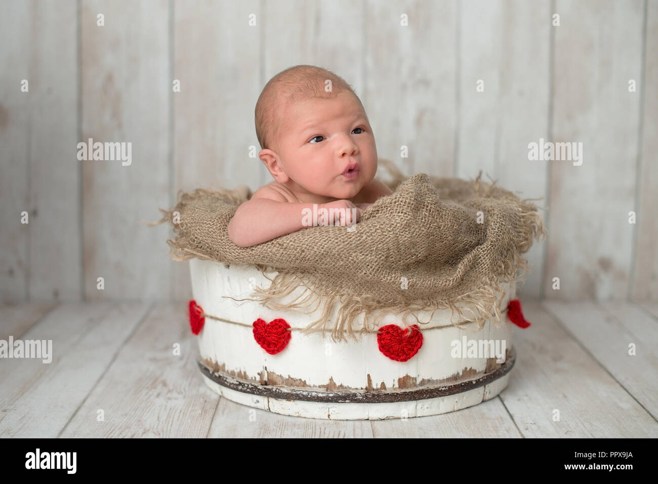 Une Alerte 10 Jours Bebe Nouveau Ne Garcon Dans Un Seau En Bois Blanc Avec Un Cœur Rouge Garland Tourne En Studio Sur Un Fond En Bois Clair Photo Stock Alamy