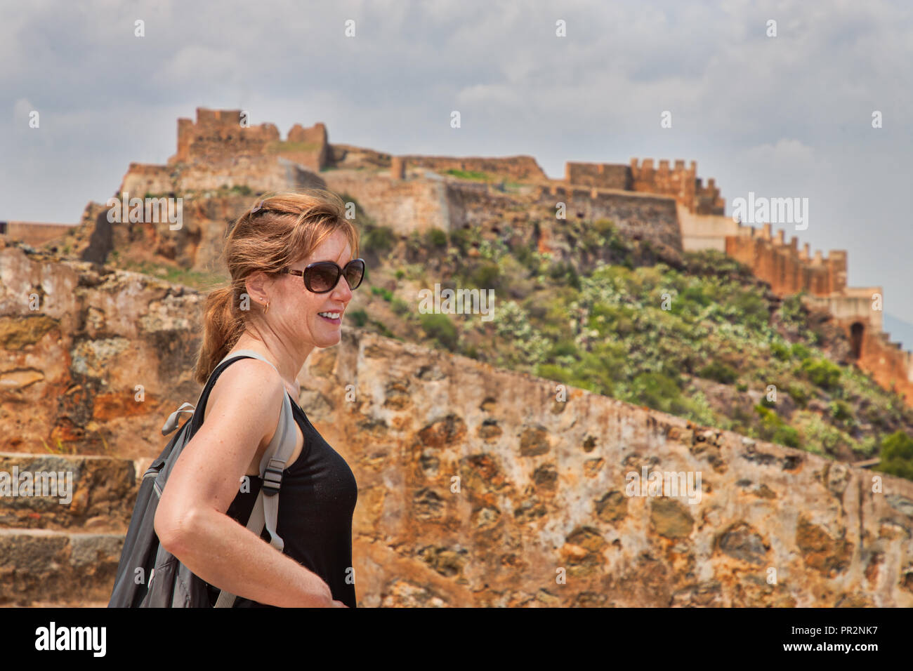 Gros plan du caucasian woman avec les ruines d'un château à Sagunto en Espagne dans l'arrière-plan Banque D'Images