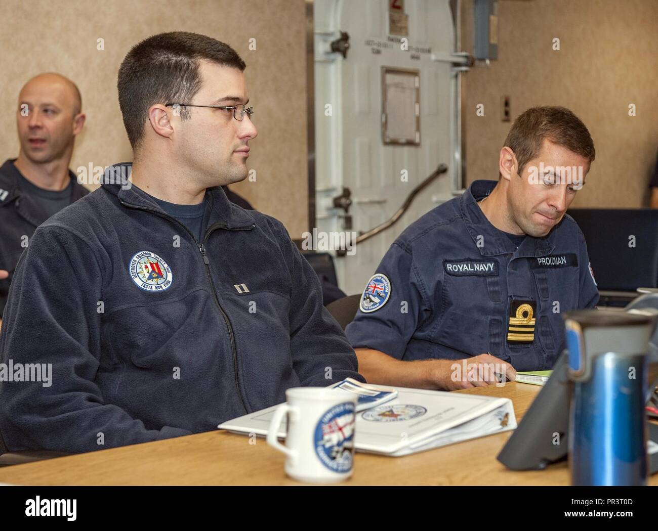 Mer Méditerranée (23 juillet 2017) L'officier des opérations de l'Escadron de destroyers 22 Le lieutenant Bruce Hallett Groupe aéronaval du Royaume-Uni et de l'exploitation. Mike Proudman conduite planification combinée à bord de porte-avions George H. W. Bush (CVN 77). Des agents de l'UKCSG sont entrepris en prévision de l'exercice guerrier Saxon keystone, un exercice que le Royaume-Uni se prépare pour l'arrivée de l'HMS Queen Elizabeth. Le GHWB et son groupe aéronaval mènent des opérations navales dans la sixième flotte américaine zone d'opérations à l'appui de la sécurité nationale des États-Unis en Europe et en Afrique. Banque D'Images